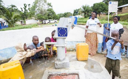 Water pump with villagers in Sierra Leone