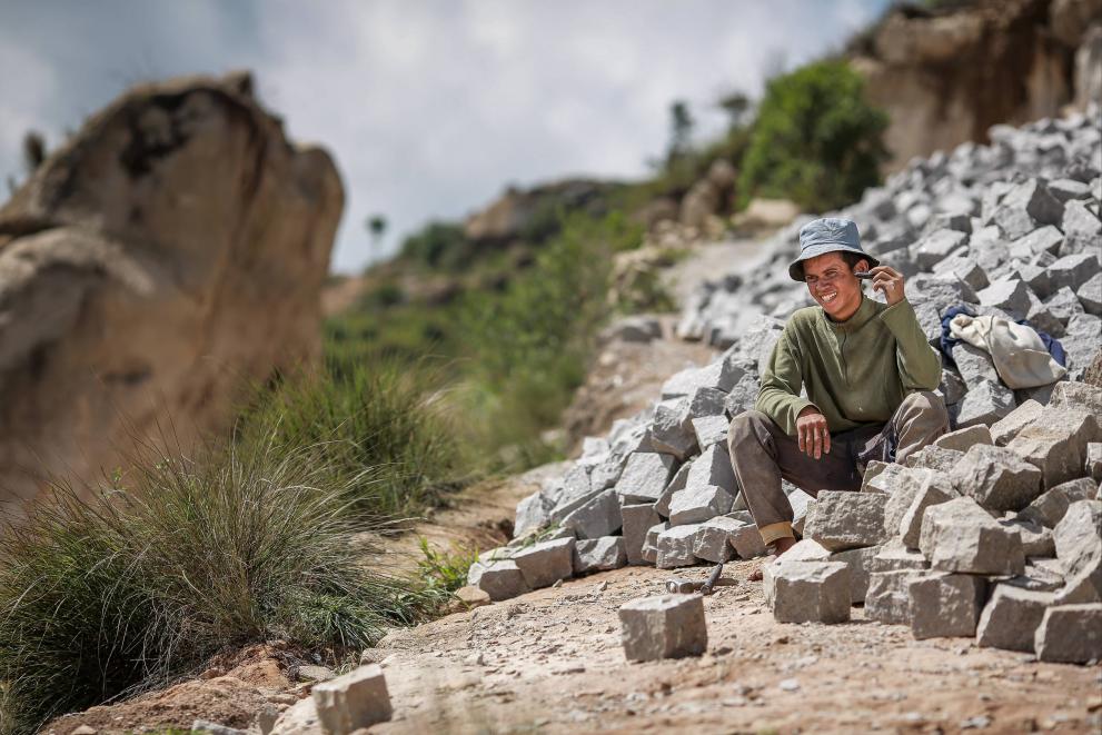 Man listening to 3-2-1 hotline in remote region of Madagascar