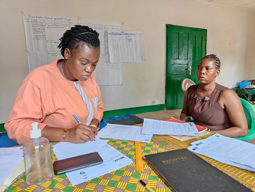 A woman in consultation with a member of the project team at a CASEF in Bangui
