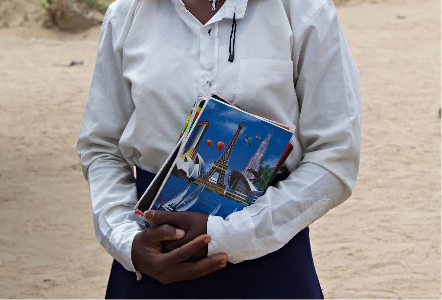 A girl in a school uniform holding books