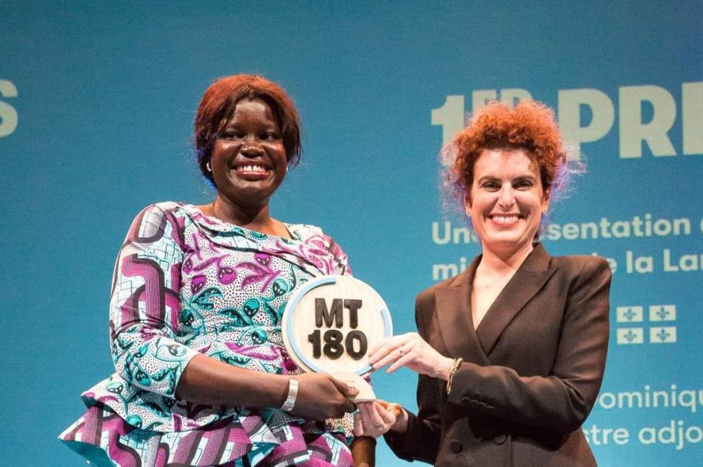 Mané Seck holding her prize and standing next to a woman who handed her the prize 