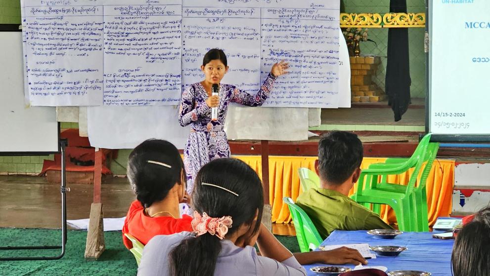 Ma Khine explaining climate change issues to local communities