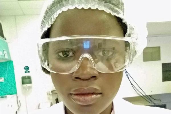 Mané Seck in laboratory equipment, close-up of her face